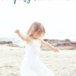 Happy preschool girl enjoying a simple day at the beach