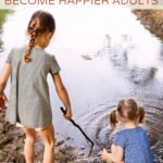 Girls playing in nature with sticks and water.