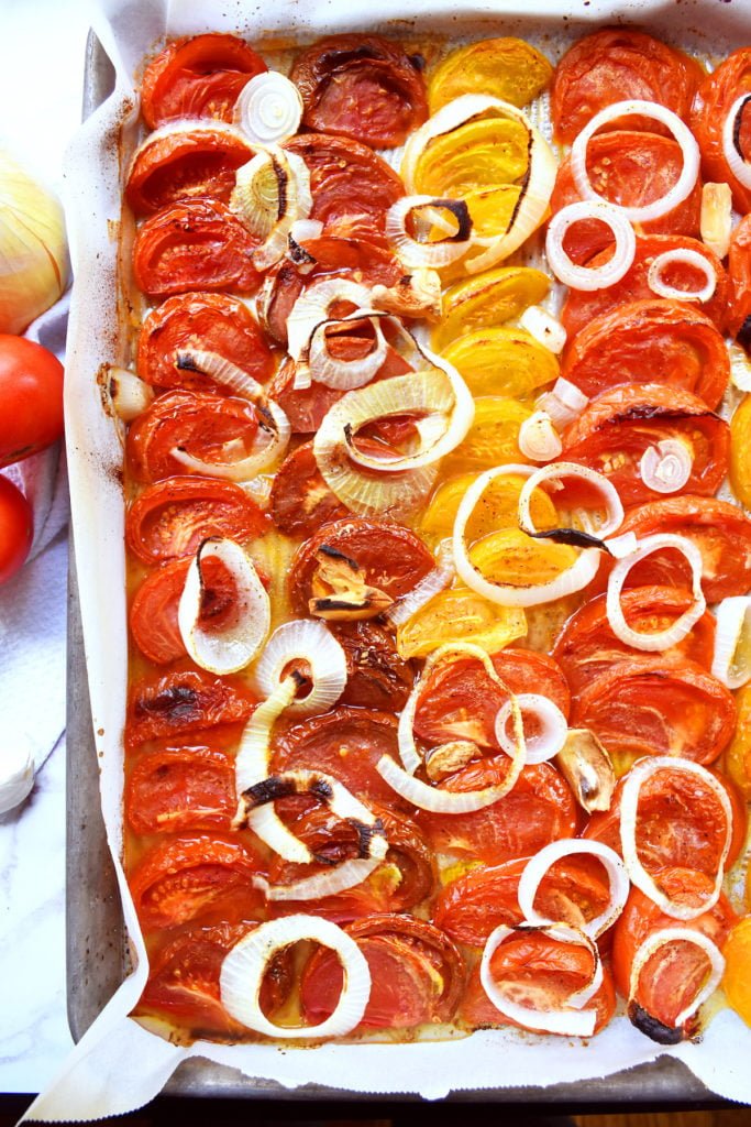 Roasted tomatoes, onions, and garlic in a large pan