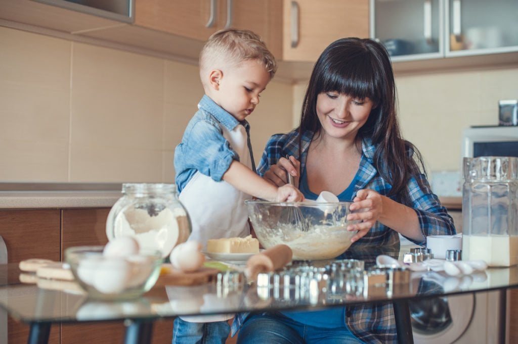 Mother and son baking together after setting expectations for behavior