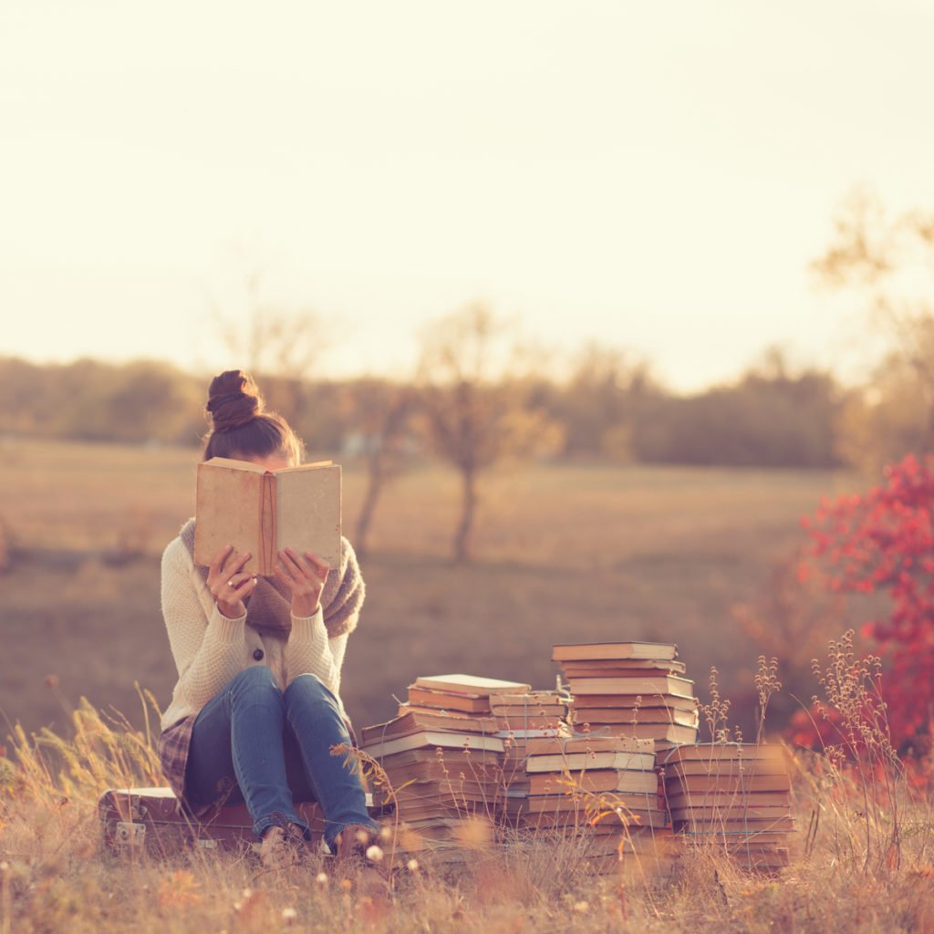 Woman reading books outside