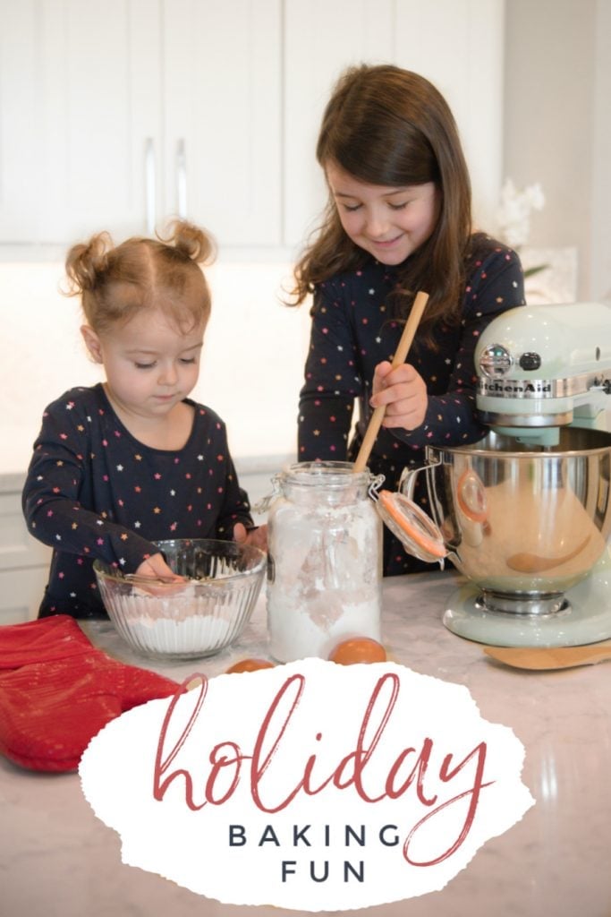 Little girls baking holiday cookies in white kitchen