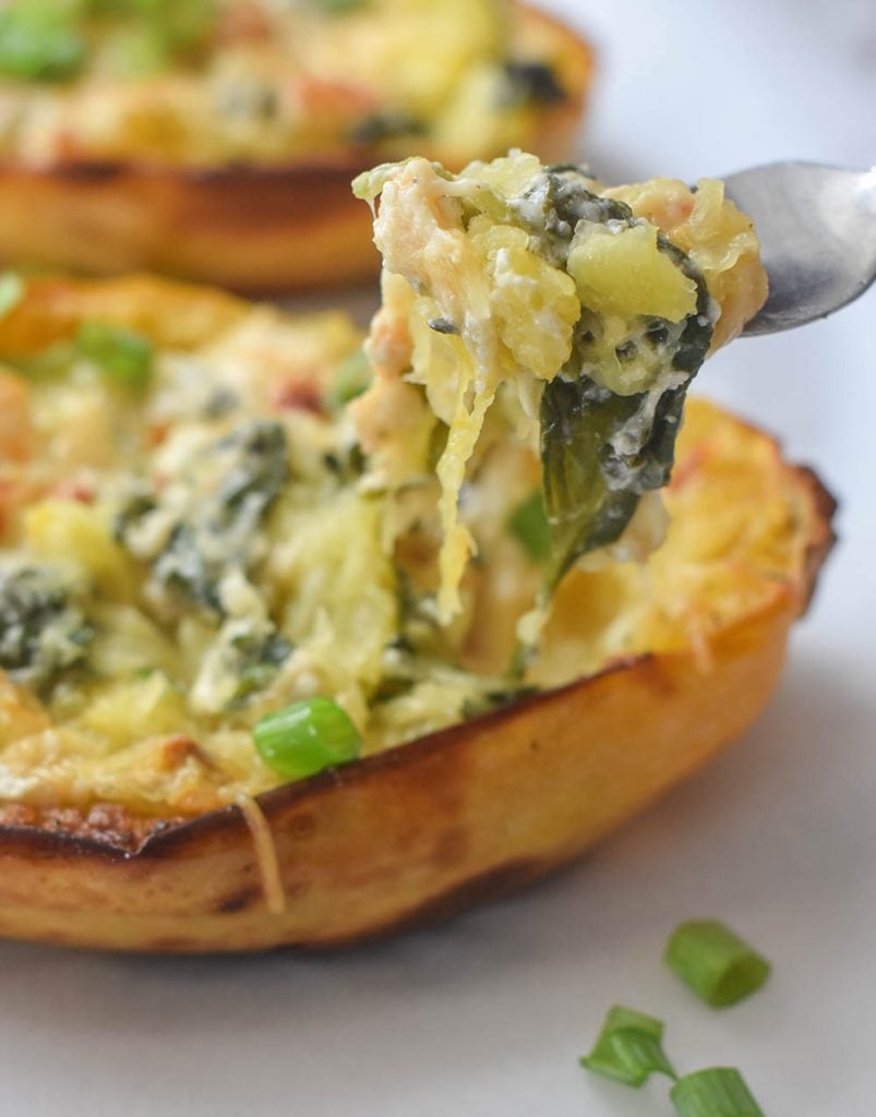 spinach and garlic stuffed spaghetti squash with fork