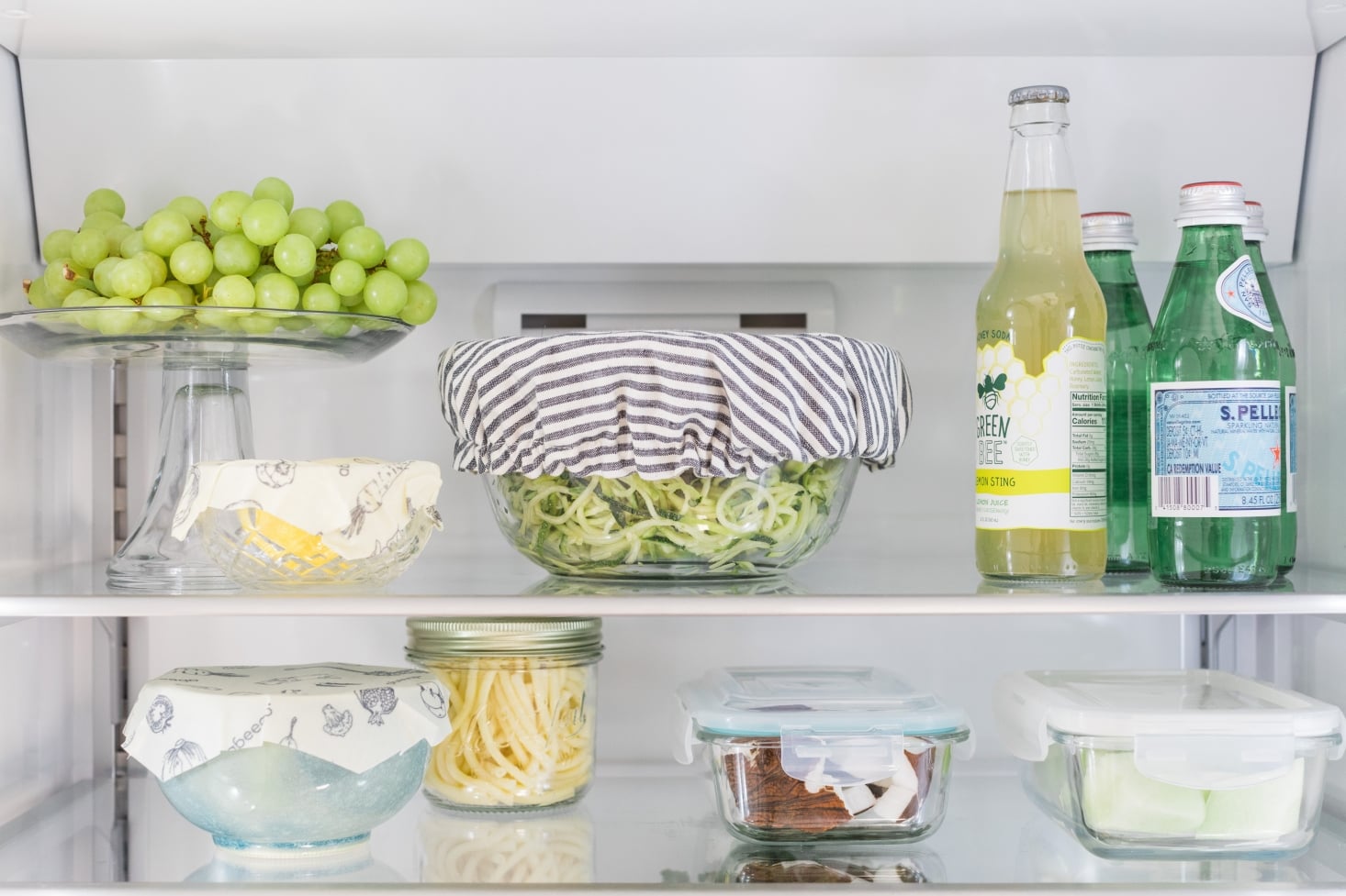 Glass and beeswax food storage in clean refrigerator