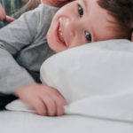 toddler boy in bed with mother