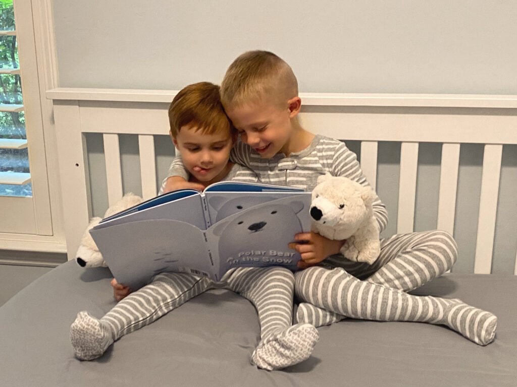 Boys reading A Polar Bear in the Snow book - Green Child Magazine