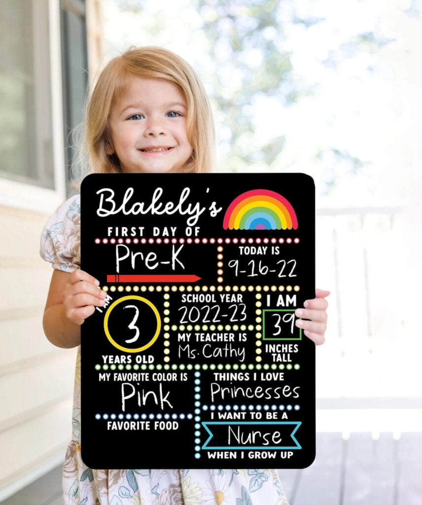 girl holding first day of school sign