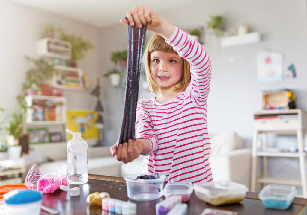 girl making glitter slime project