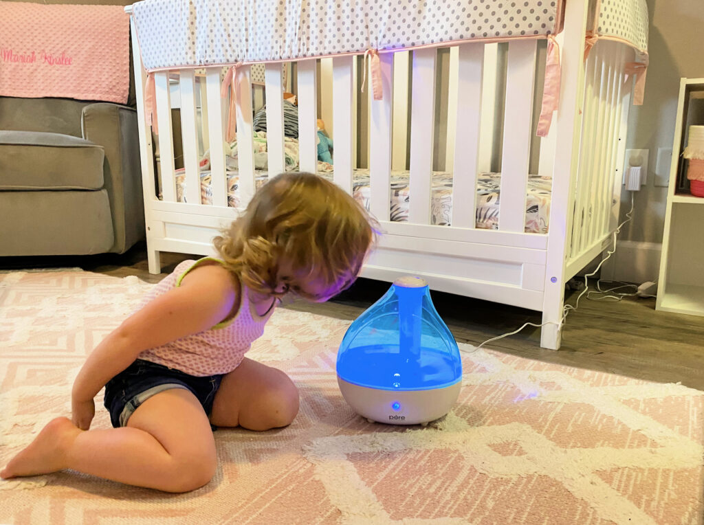 baby and humidifier in nursery