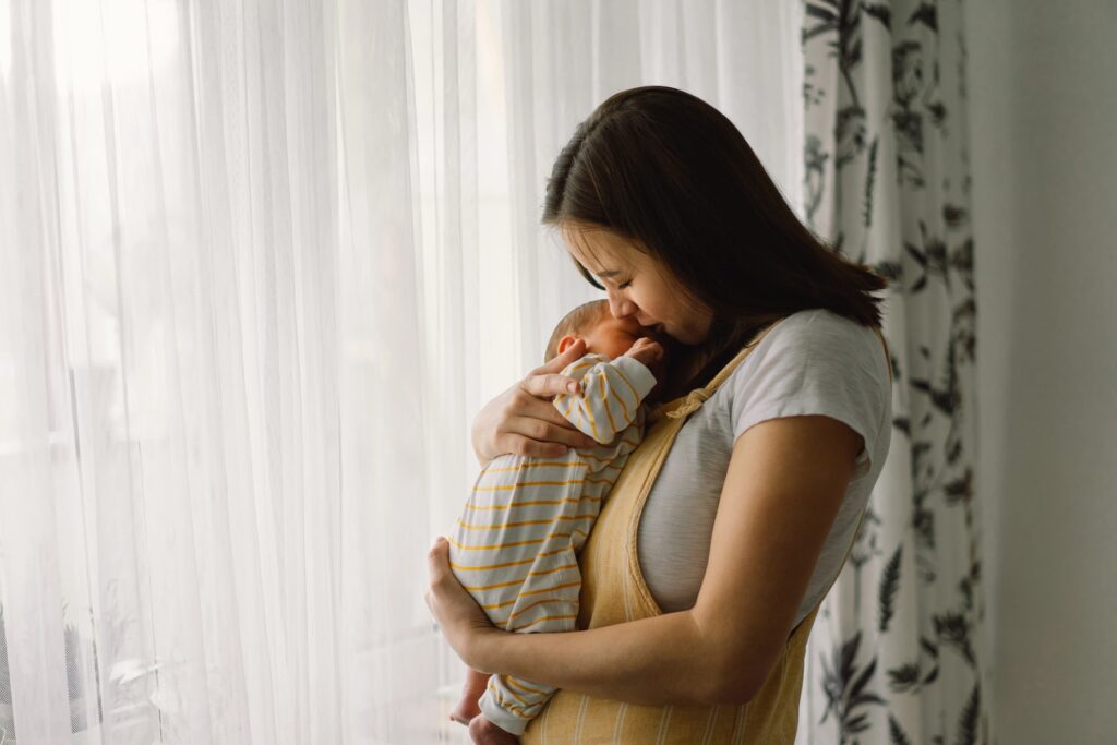 mother holding infant baby