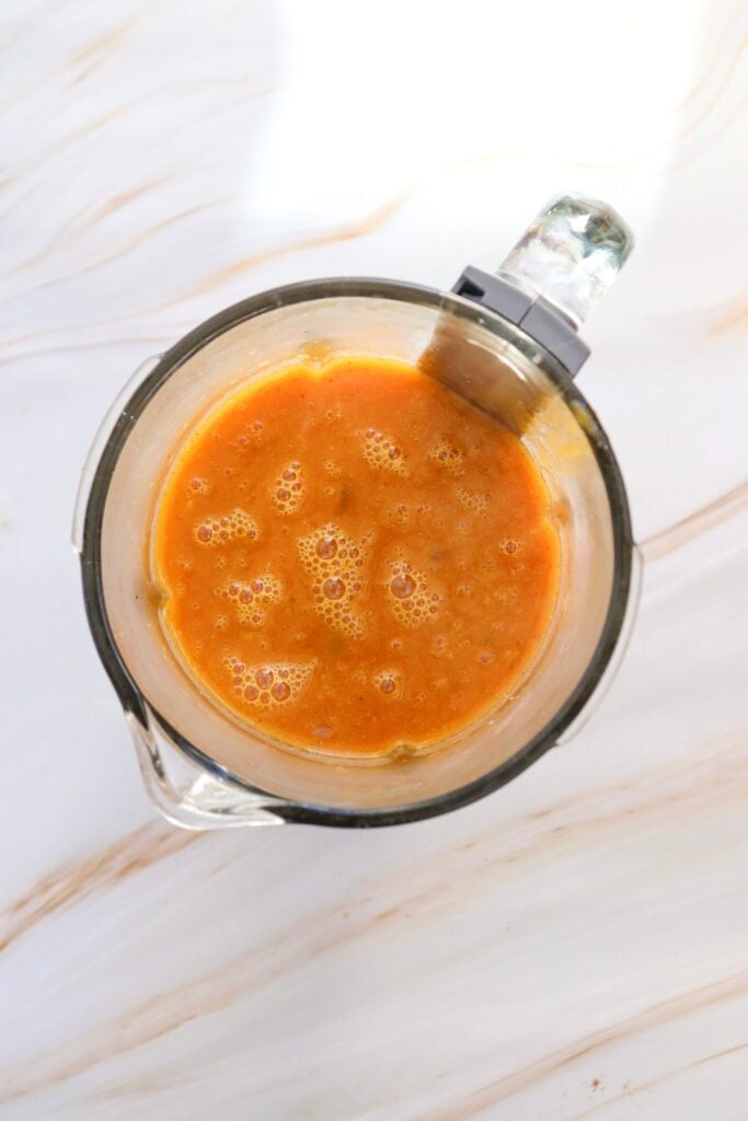 creamy pumpkin soup in measure cup
